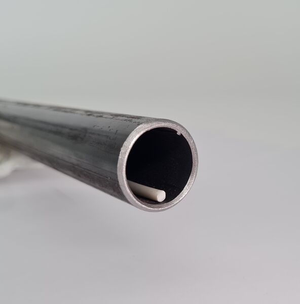 One metal tube with forward-facing opening and white BioCor® corrosion protection cable inside.