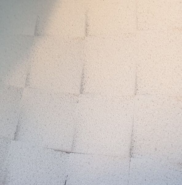 Close-up of square cut-outs made from BioCor® corrosion protection foam, positioned close together.
