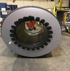 Steel coil packed in a warehouse with internal edge protection.